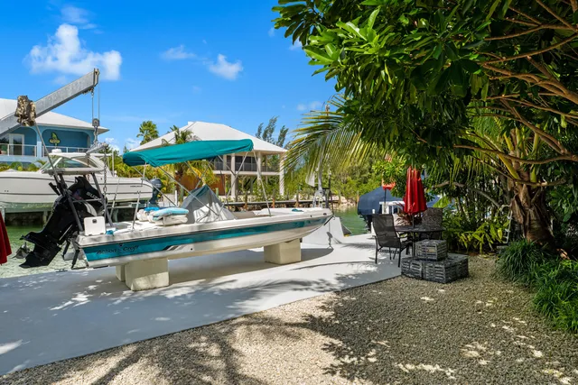 a view of a house with a yard and lake view
