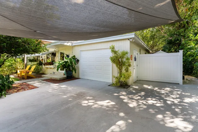 a kitchen with white cabinets and sink