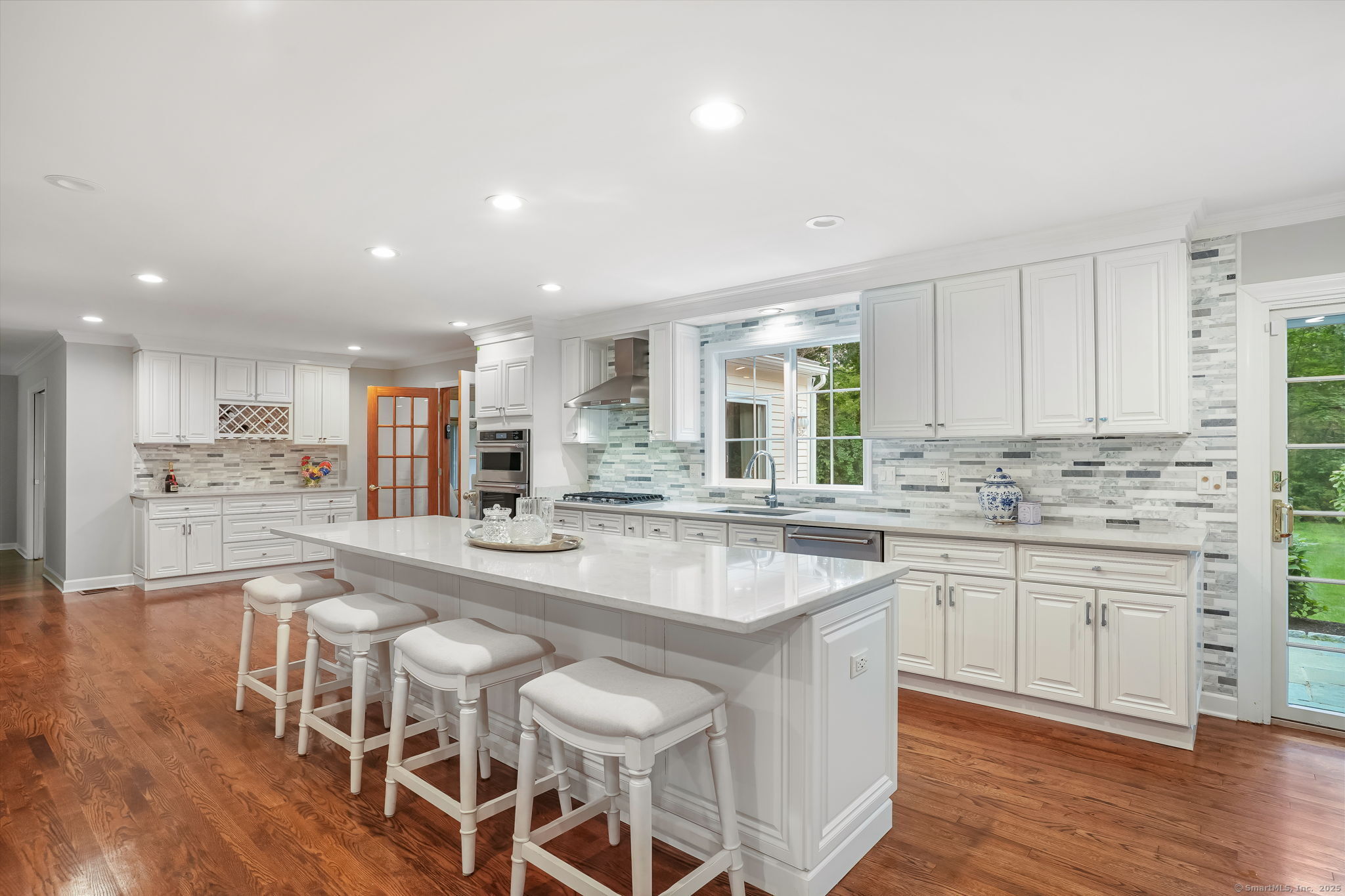 22 Fox Run Wilton, CT 06897 - Photo 21 of 40 a kitchen with stainless steel appliances granite countertop a table chairs sink and cabinets