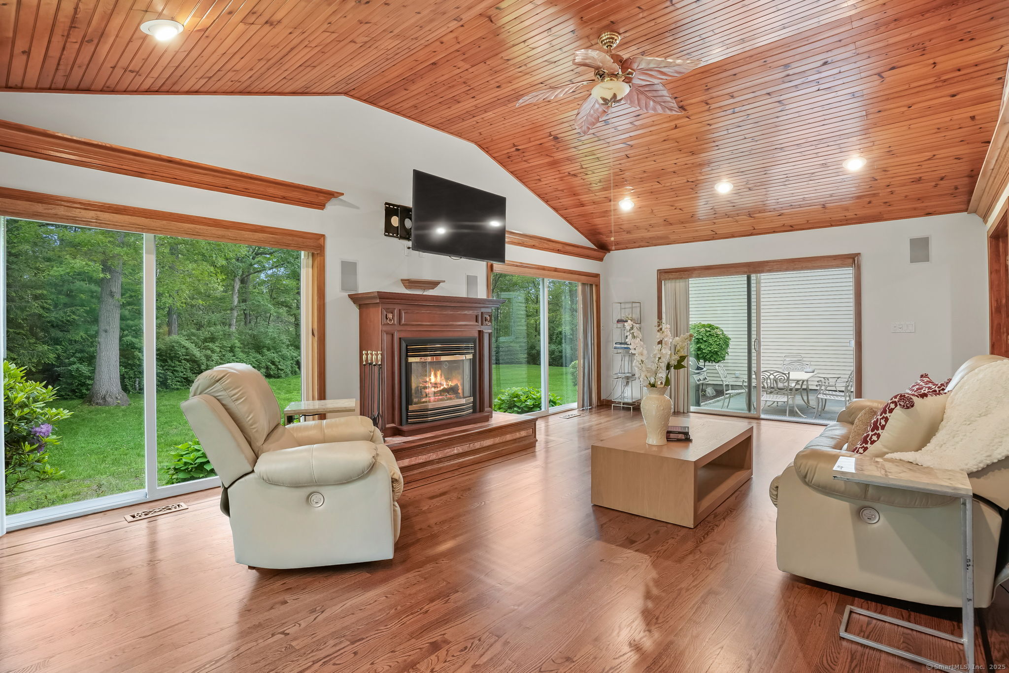 22 Fox Run Wilton, CT 06897 - Photo 24 of 40 a living room with furniture a fireplace and floor to ceiling windows