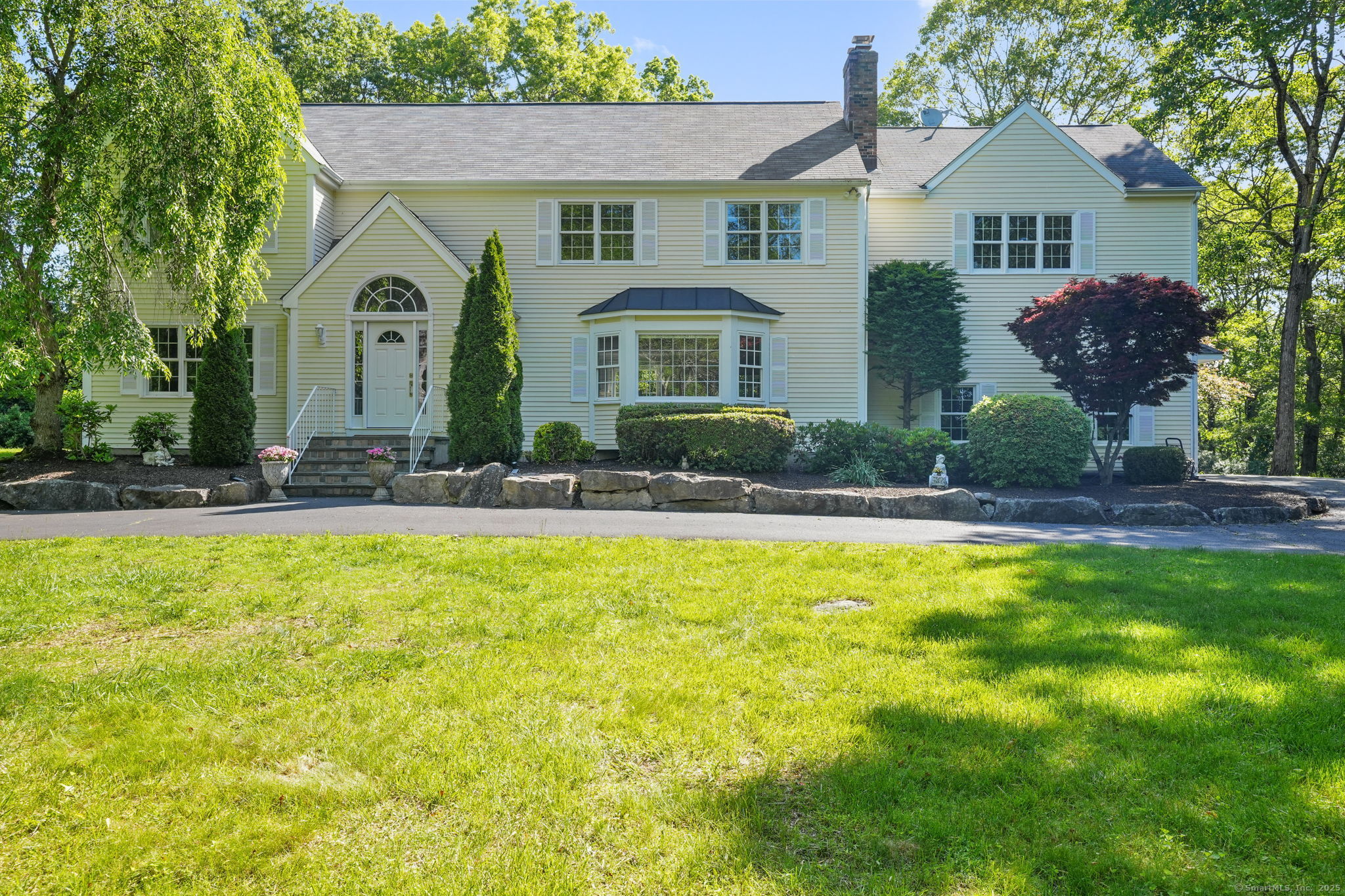22 Fox Run Wilton, CT 06897 - Photo 5 of 40 a front view of a house with a yard