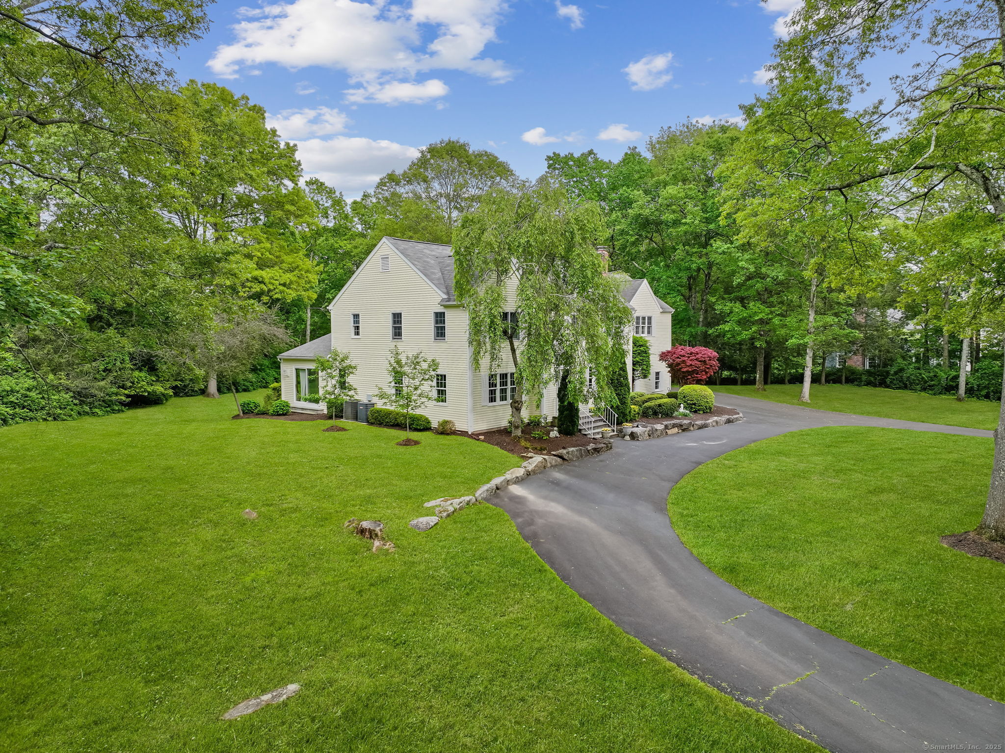 22 Fox Run Wilton, CT 06897 - Photo 6 of 40 a view of a house with a big yard potted plants and large tree