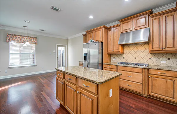 a kitchen with stainless steel appliances granite countertop a sink stove and cabinets