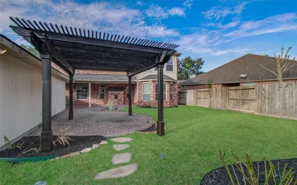 a view of a backyard with plants and a patio