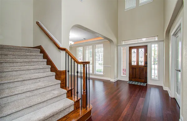 a view of an entryway with wooden floor and stairs