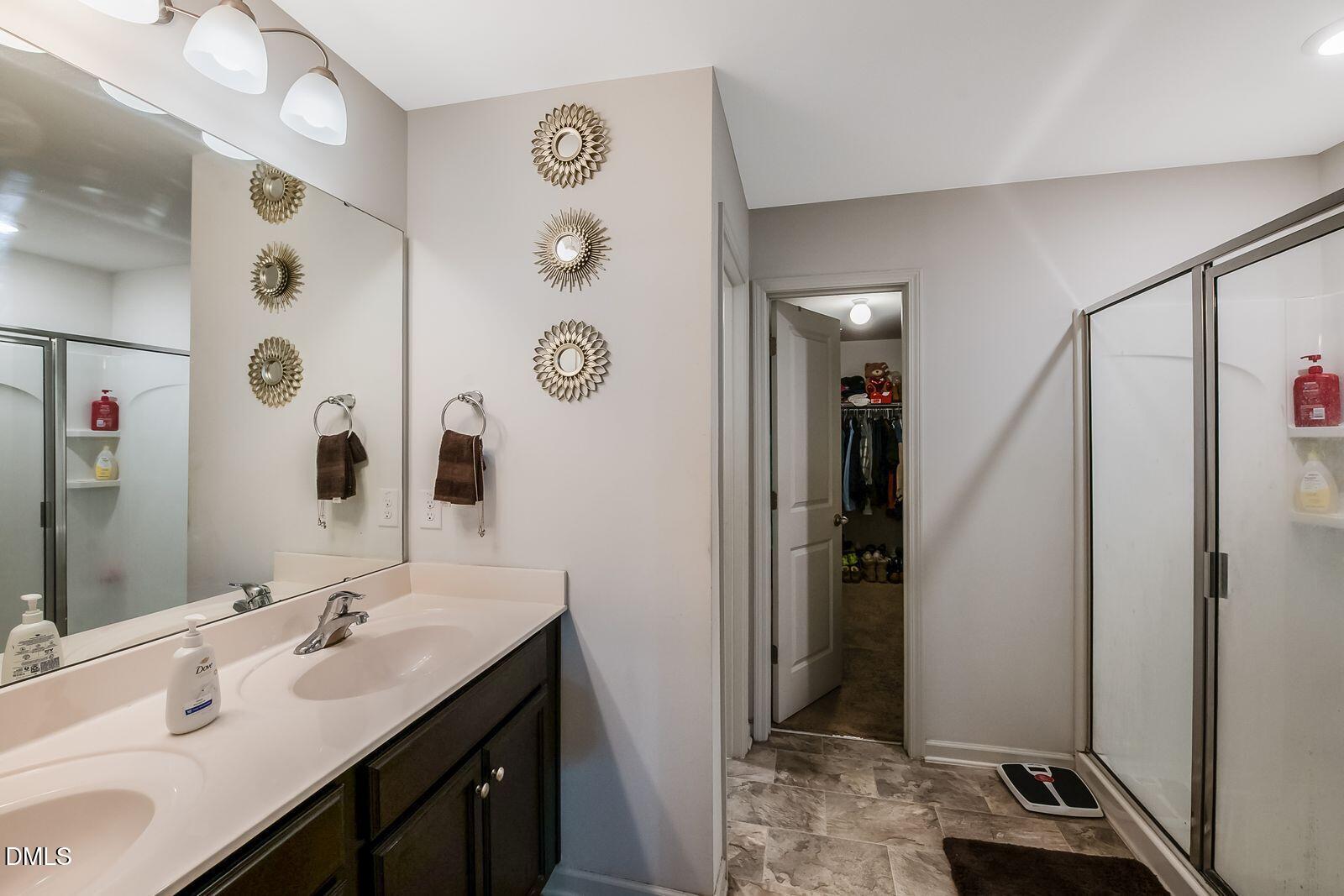 67 Prairie Street Clayton, NC 27527 - Photo 16 of 20 a bathroom with a sink and a mirror
