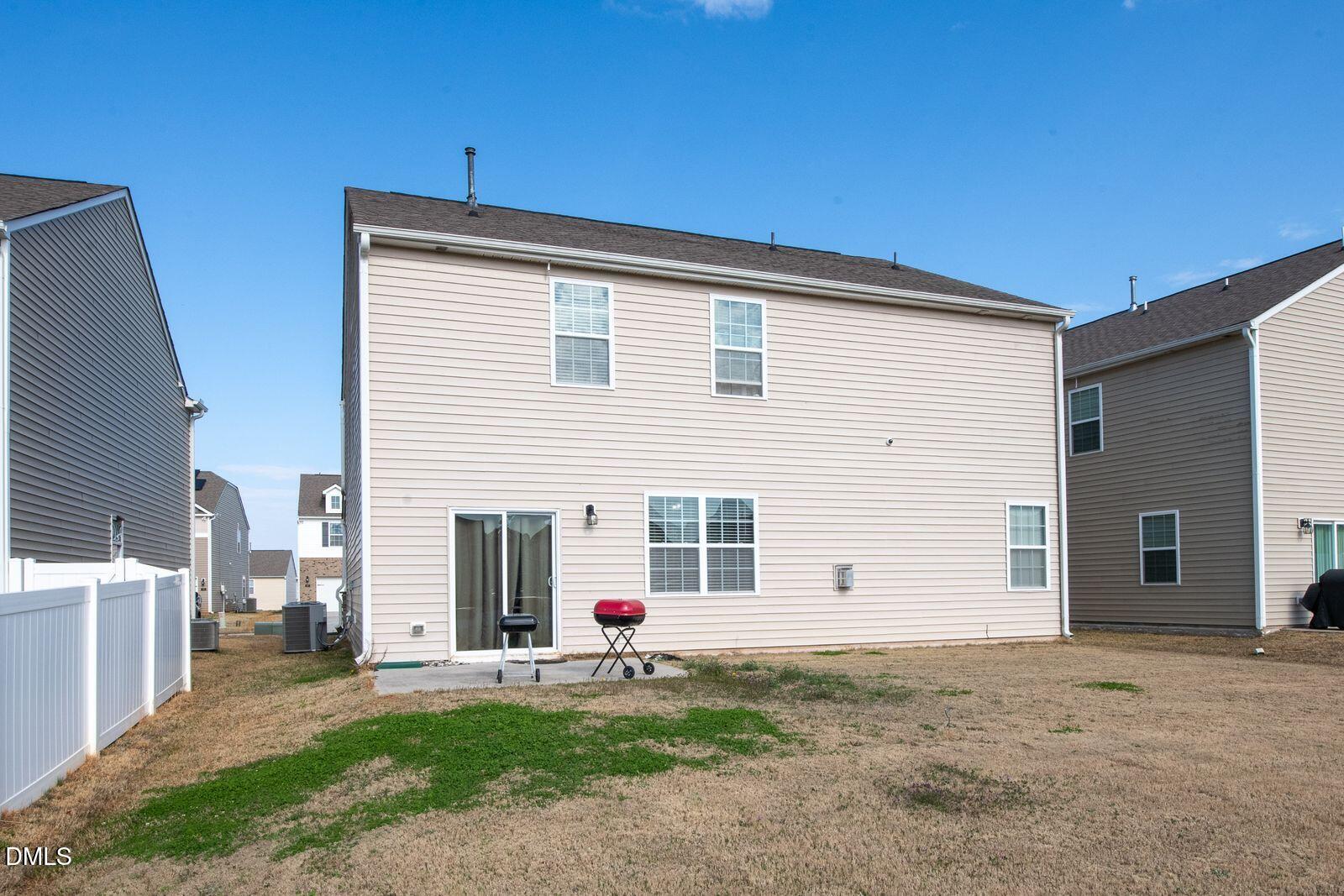 67 Prairie Street Clayton, NC 27527 - Photo 20 of 20 a front view of a house with a yard and garage