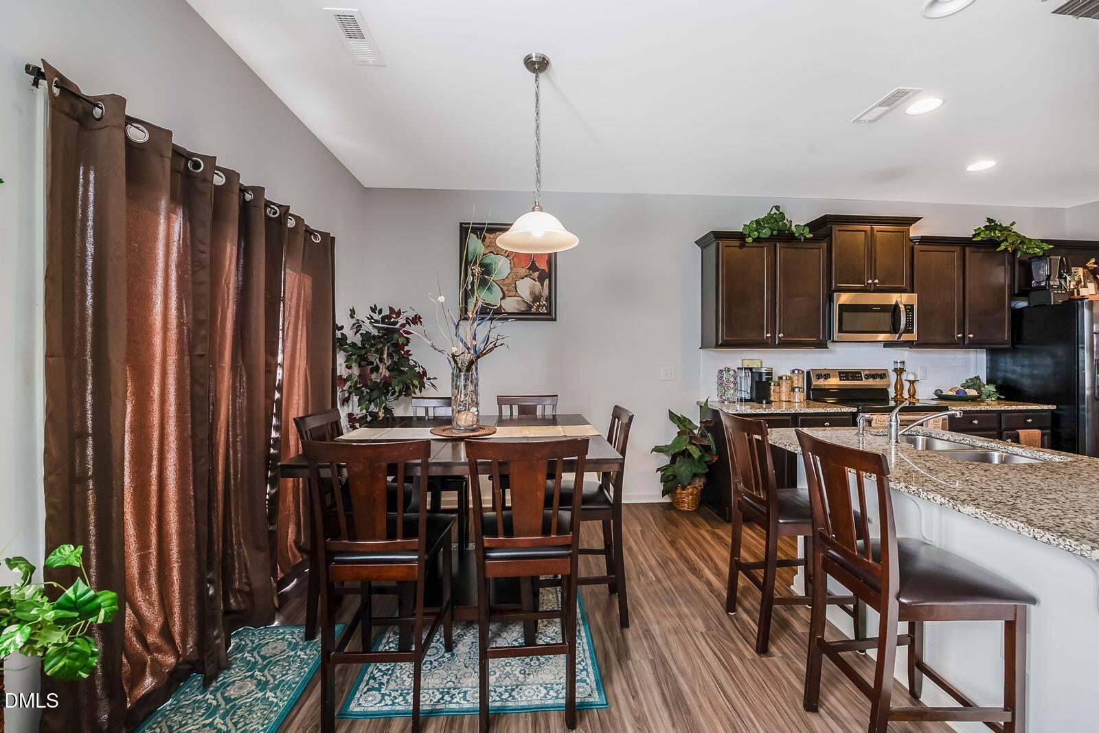 67 Prairie Street Clayton, NC 27527 - Photo 6 of 20 a view of a dining room with furniture window and wooden floor