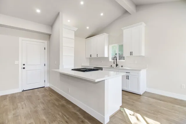 a kitchen with a sink stove and cabinets