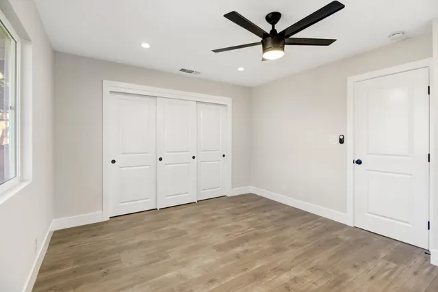a view of a livingroom with a ceiling fan & window