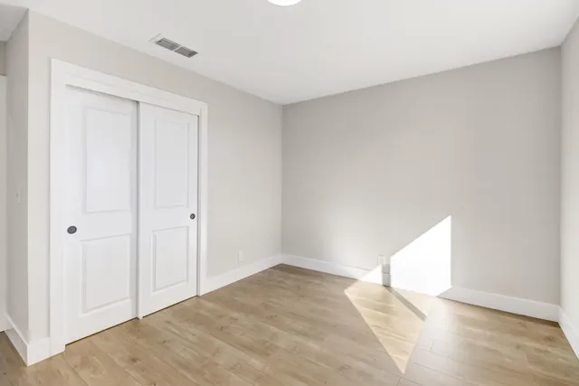 a view of an empty room and wooden floor