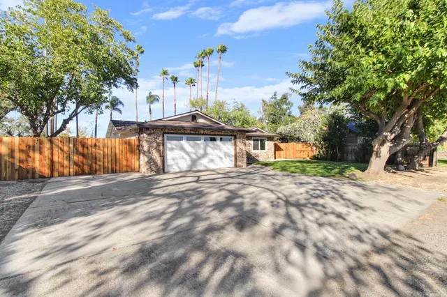 a view of a yard with large trees