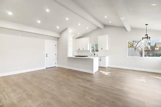 a view of kitchen with kitchen island and stainless steel appliances