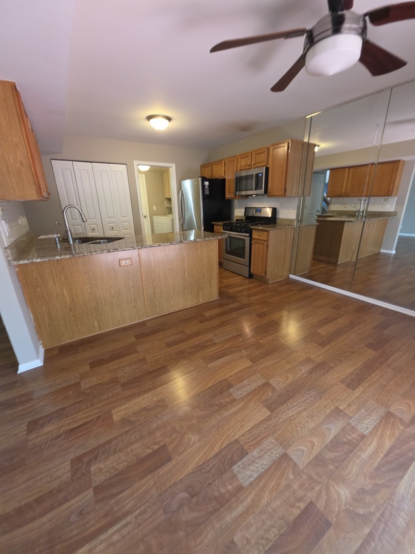 407 Spaulding Road, Unit 407 Bartlett, IL 60103 - Photo 17 of 25 a view of kitchen with cabinets and wooden floor