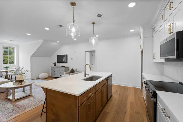a kitchen with a sink a counter space and stainless steel appliances