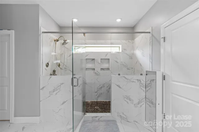 a bedroom with a bed flat screen tv and window