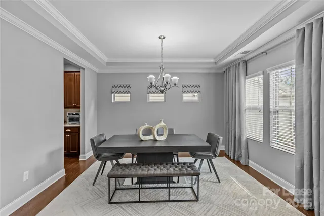 a view of a dining room with furniture and chandelier