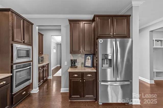 a kitchen with granite countertop stainless steel appliances and cabinets