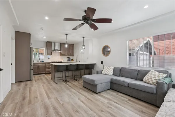 a living room with furniture and kitchen view