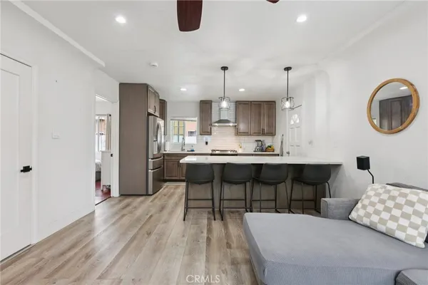 a kitchen with a dining table chairs and cabinets