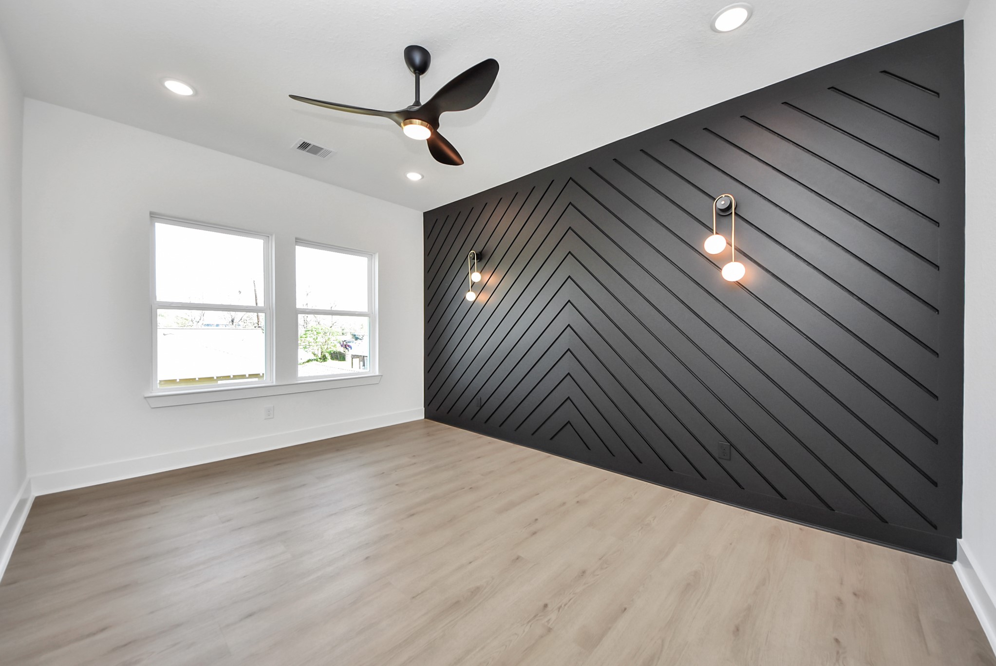 3319 Caplin Street Houston, TX 77026 - Photo 20 of 42 a view of empty room with wooden floor and fan