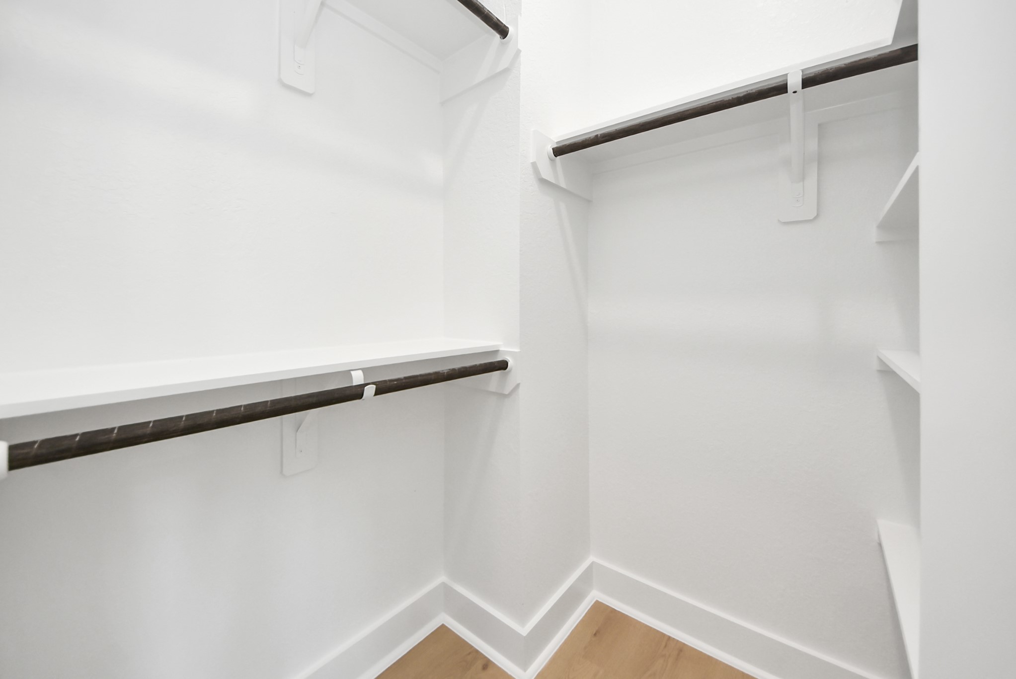 3319 Caplin Street Houston, TX 77026 - Photo 25 of 42 a view of walk in closet with empty racks