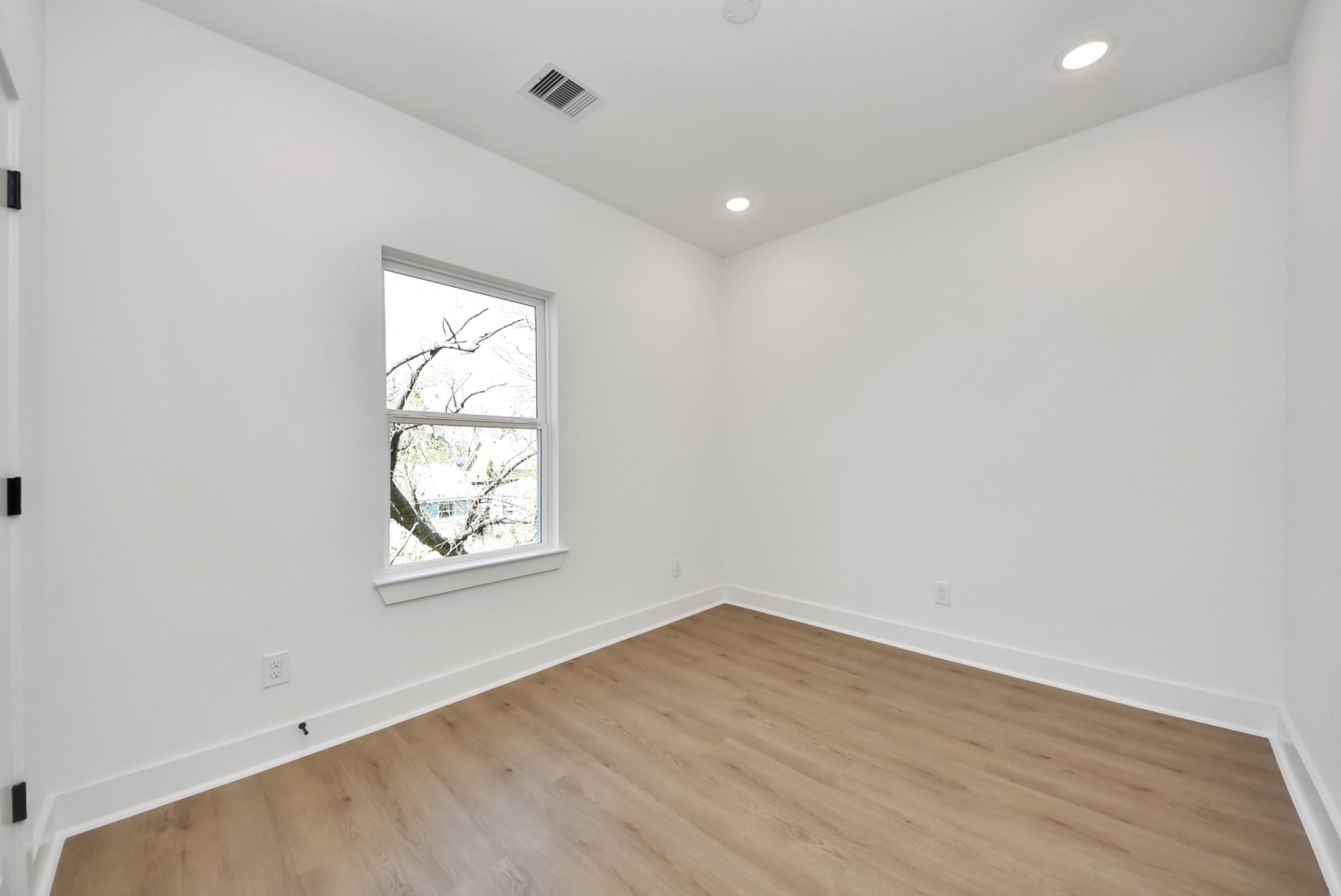 3319 Caplin Street Houston, TX 77026 - Photo 26 of 42 an empty room with wooden floor and windows