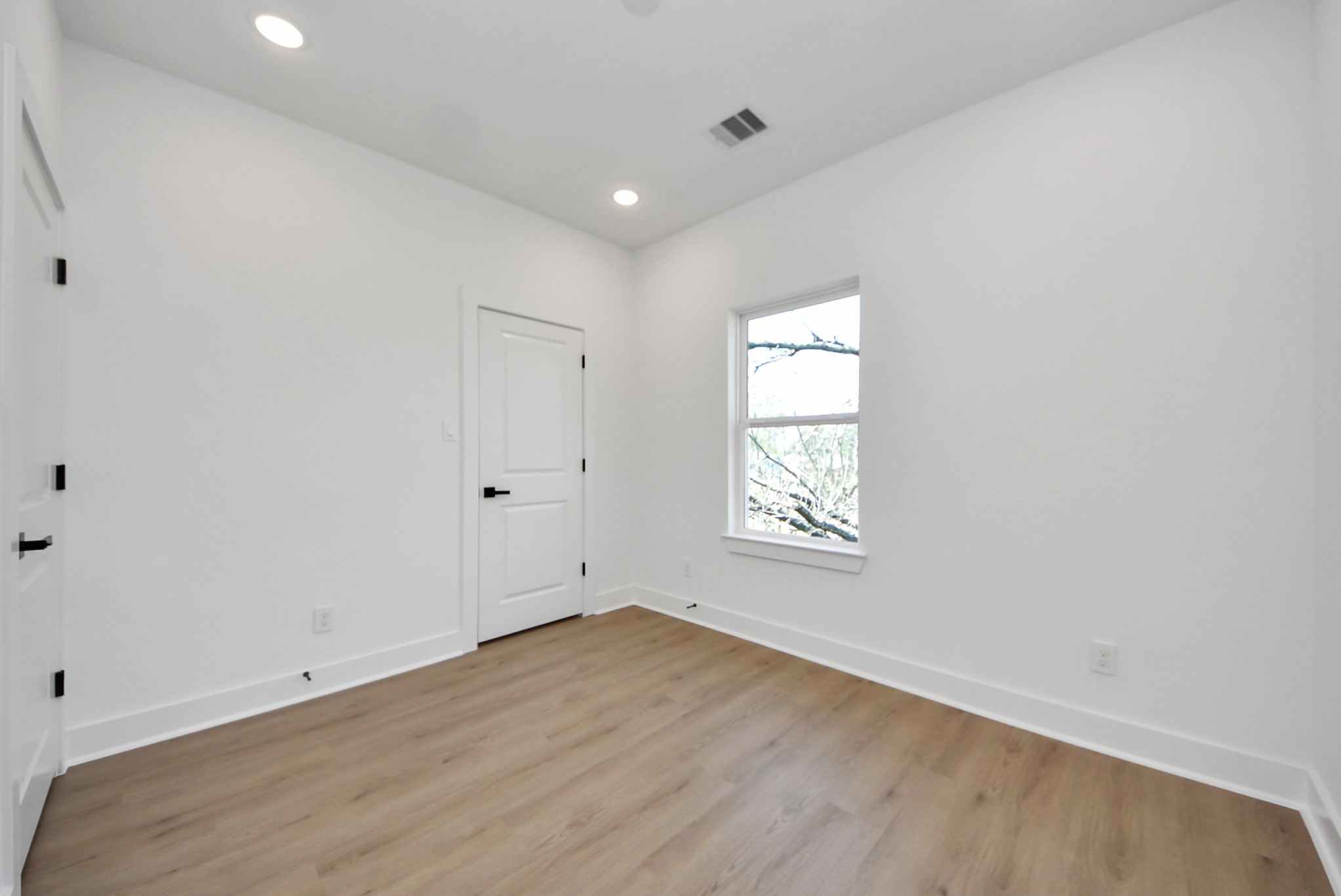 3319 Caplin Street Houston, TX 77026 - Photo 28 of 42 an empty room with wooden floor and windows