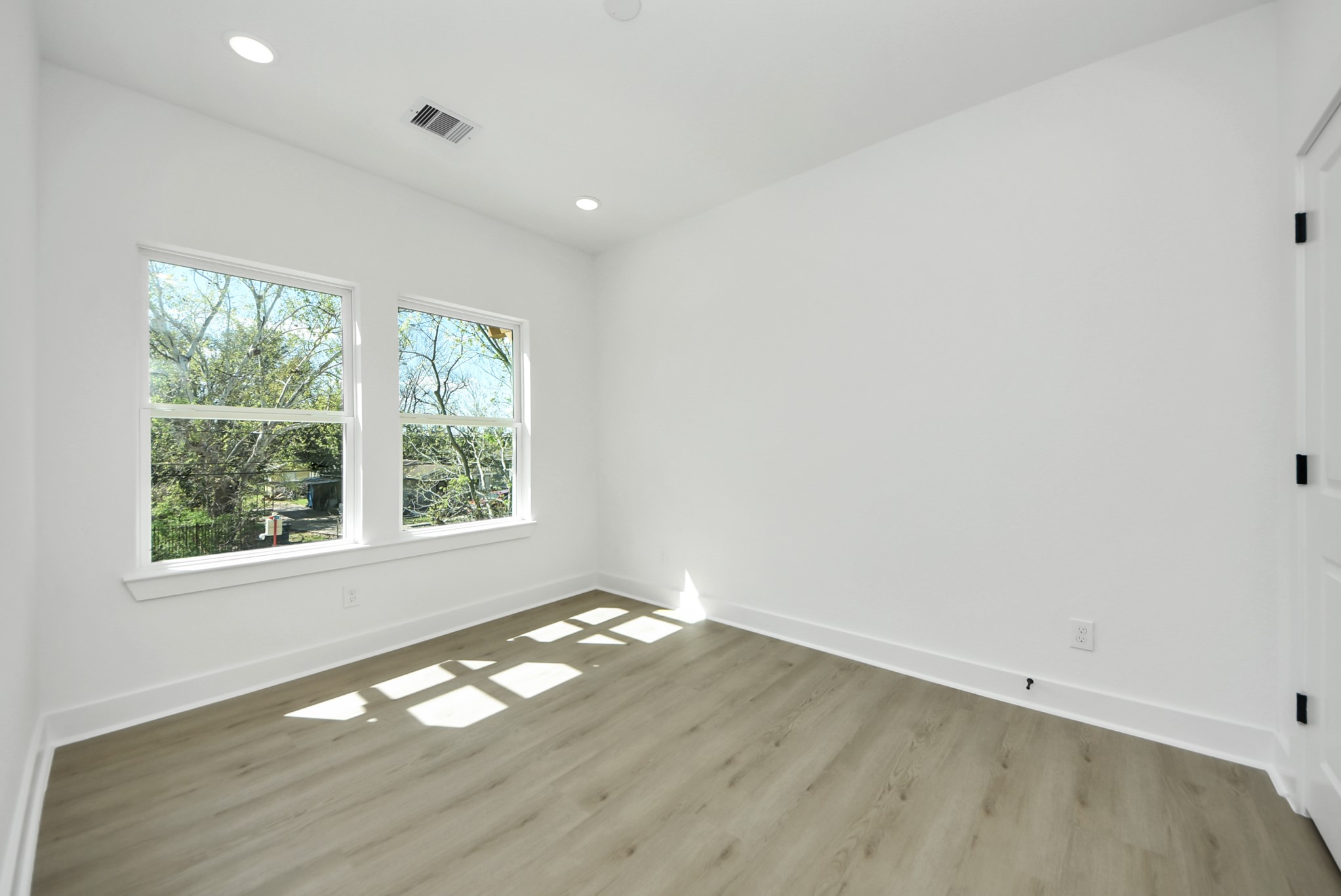 3319 Caplin Street Houston, TX 77026 - Photo 29 of 42 an empty room with wooden floor and windows
