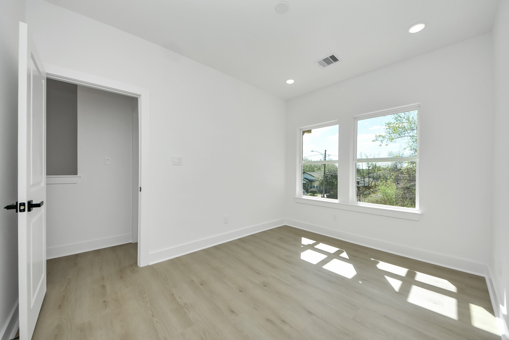 3319 Caplin Street Houston, TX 77026 - Photo 30 of 42 a view of empty room with wooden floor and fan