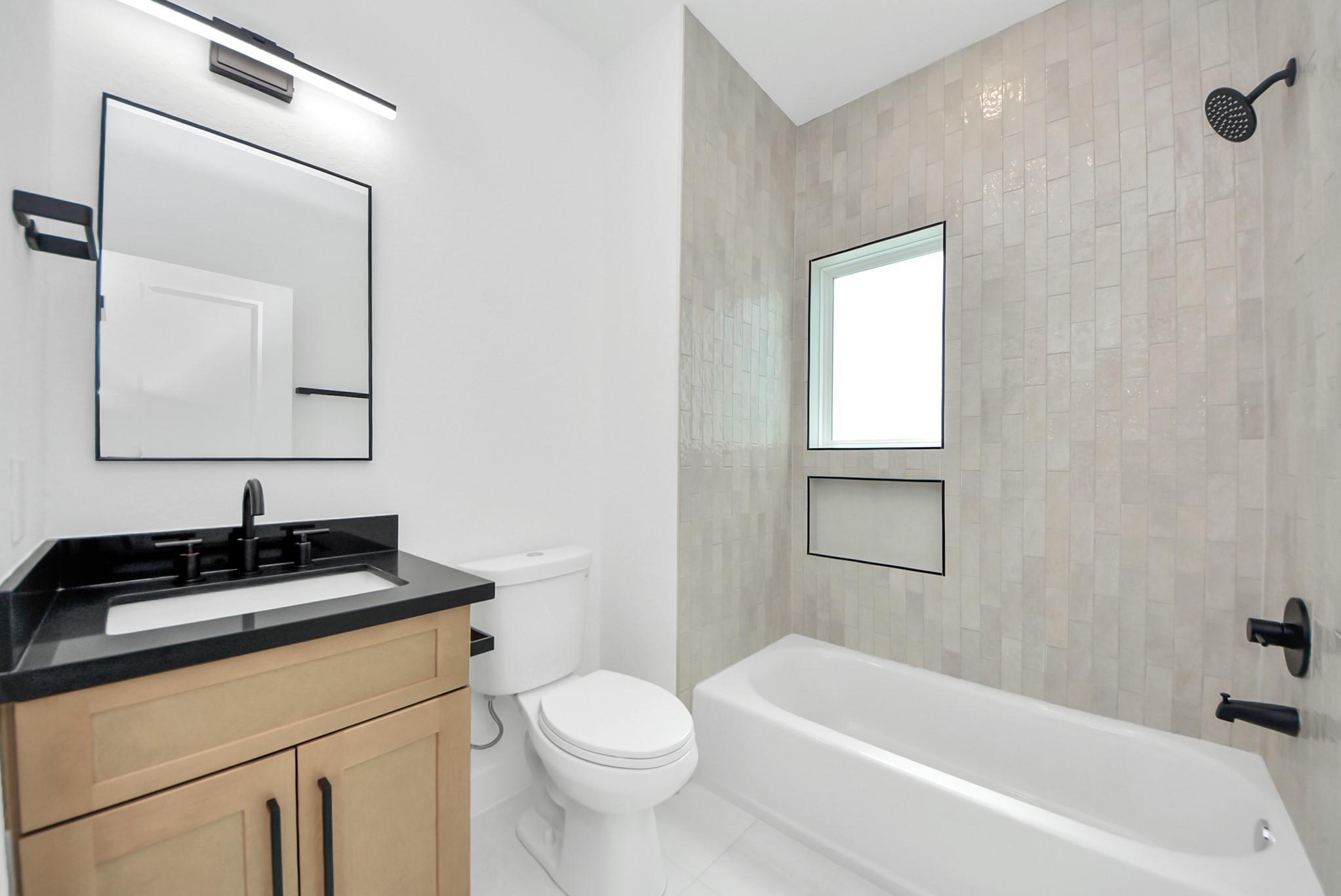 3319 Caplin Street Houston, TX 77026 - Photo 33 of 42 a bathroom with a granite countertop sink a toilet and bathtub