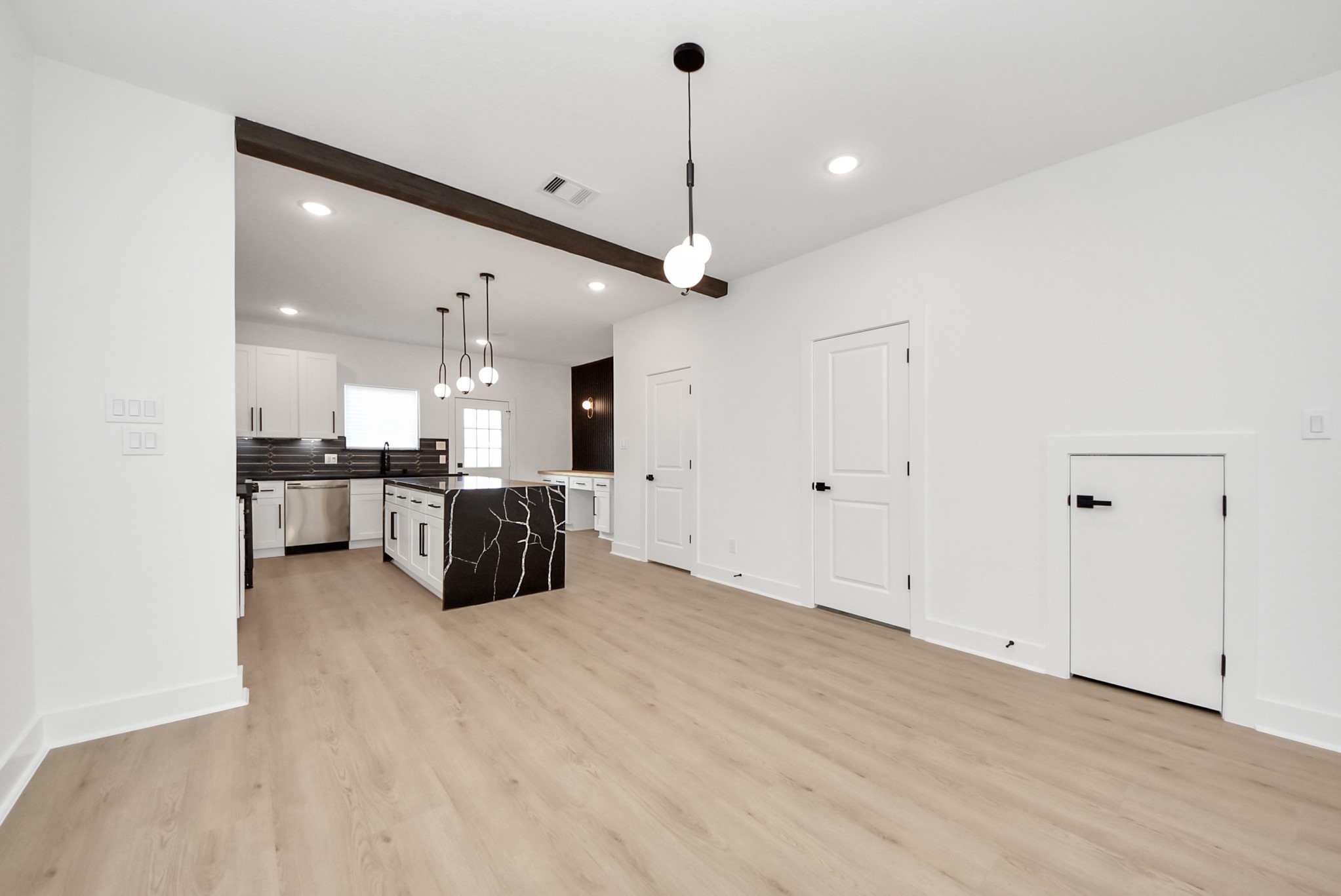 3319 Caplin Street Houston, TX 77026 - Photo 9 of 42 a large kitchen with stainless steel appliances kitchen island granite countertop a sink and cabinets