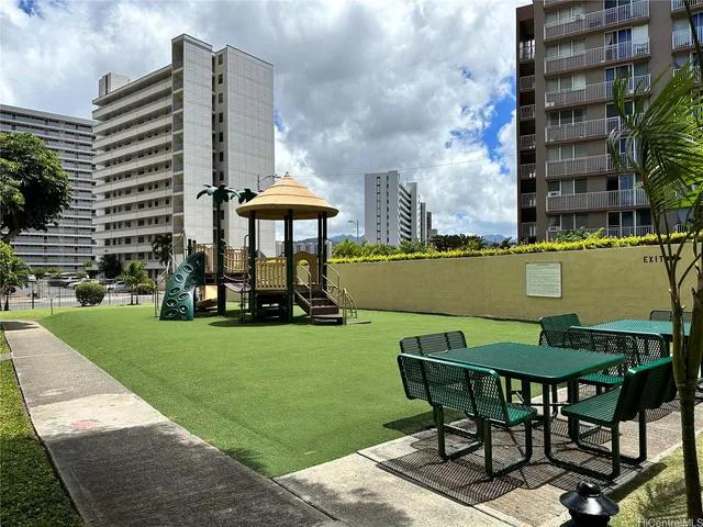 a view of a patio with a table and chairs under an umbrella