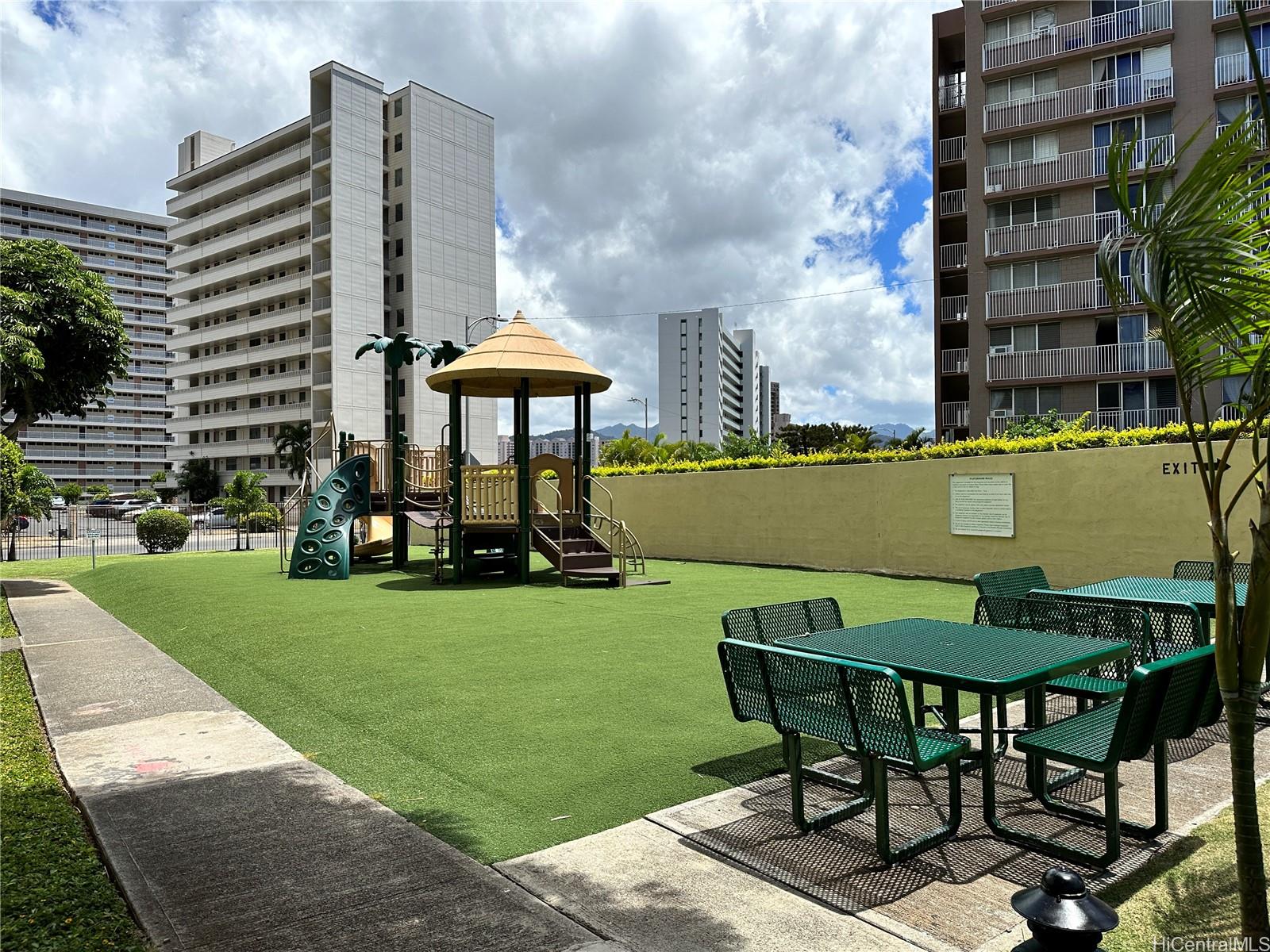 3161 Ala Ilima Street, Unit 903 Honolulu, HI 96818 - Photo 14 of 15 a view of a patio with a table and chairs under an umbrella