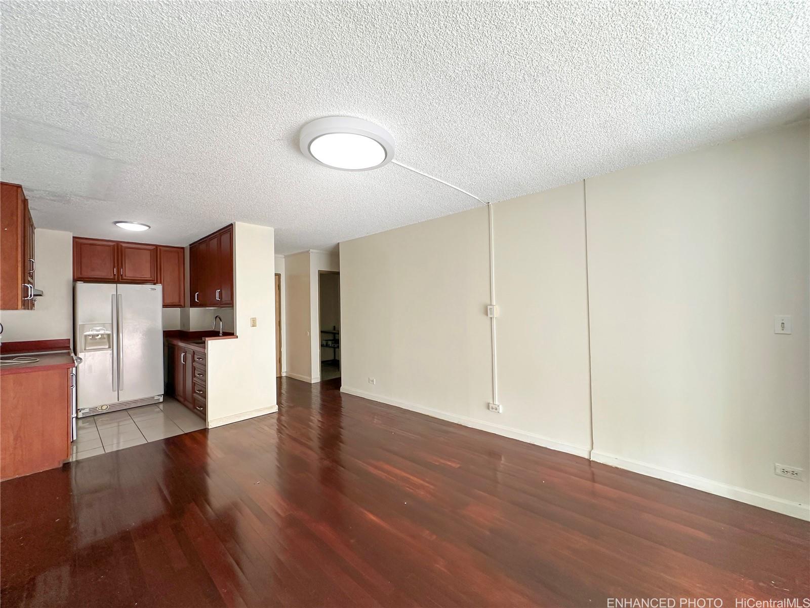 3161 Ala Ilima Street, Unit 903 Honolulu, HI 96818 - Photo 3 of 15 a view of a kitchen with a refrigerator and a stove top oven