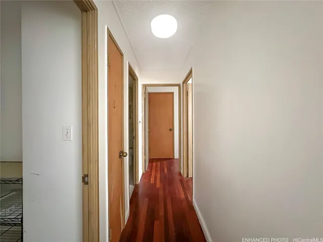 a view of a hallway with wooden floor