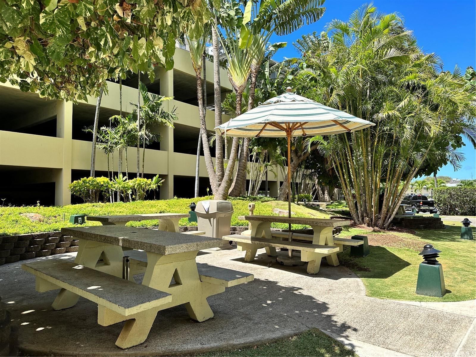 3161 Ala Ilima Street, Unit 903 Honolulu, HI 96818 - Photo 10 of 15 a view of a patio with table and chairs under an umbrella