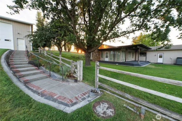 a view of a house with backyard porch and sitting area