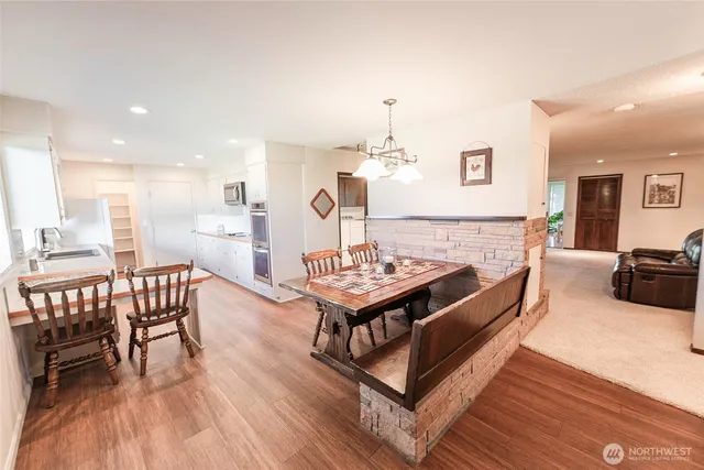 a living room with furniture a table and wooden floor