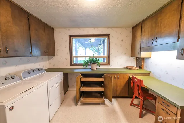 a room with a sink cabinets and window