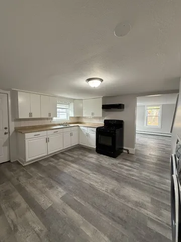 a large kitchen with cabinets and stainless steel appliances