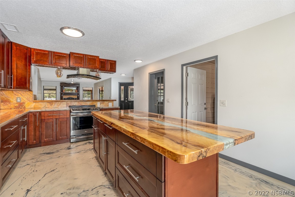 Undisclosed Address Edgewater, FL 32141 - Photo 12 of 37 a kitchen with a stove sink and cabinets