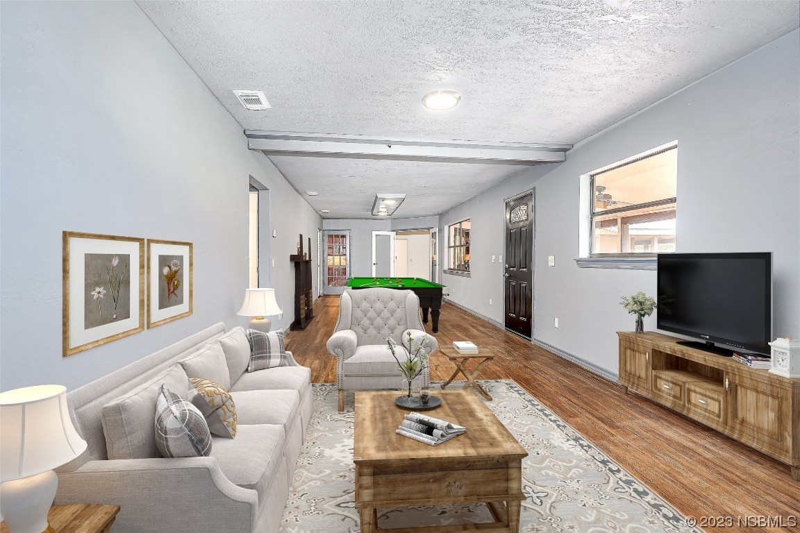 Undisclosed Address Edgewater, FL 32141 - Photo 15 of 37 a living room with furniture and a flat screen tv