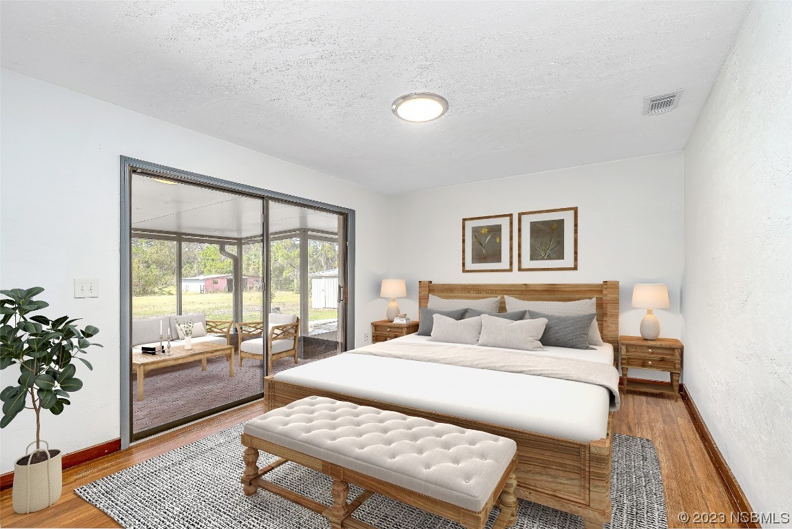 Undisclosed Address Edgewater, FL 32141 - Photo 19 of 37 a bedroom with a bed and a couch