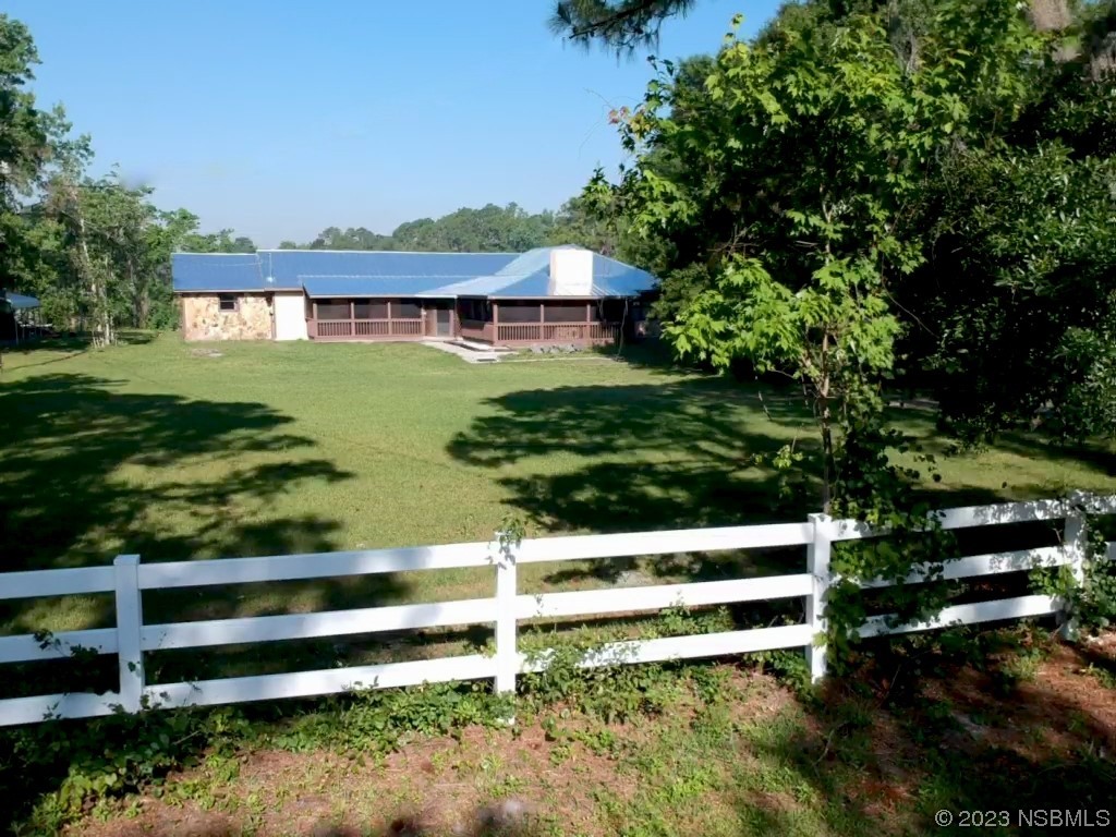 Undisclosed Address Edgewater, FL 32141 - Photo 2 of 37 a view of a house with a yard