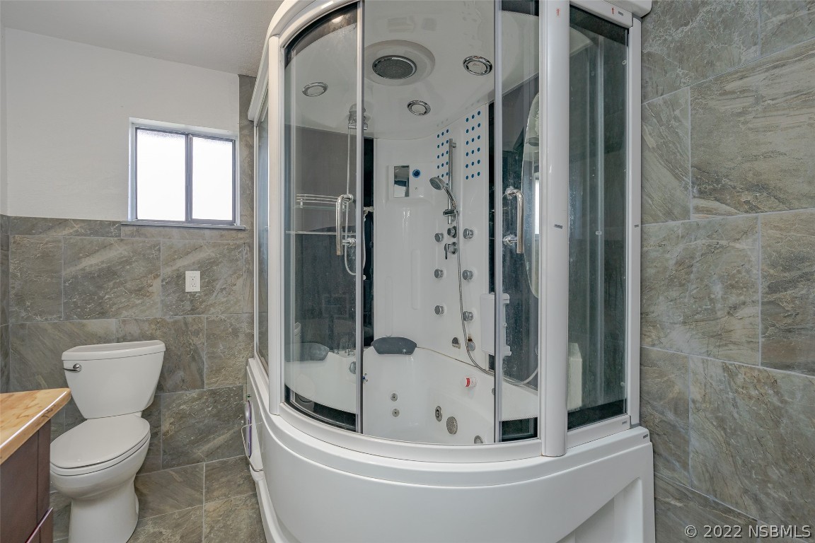 Undisclosed Address Edgewater, FL 32141 - Photo 28 of 37 a bathroom with a bathtub and toilet