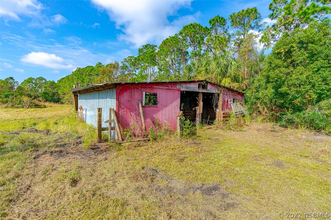 Undisclosed Address Edgewater, FL 32141 - Photo 35 of 37 a front view of a house with garden