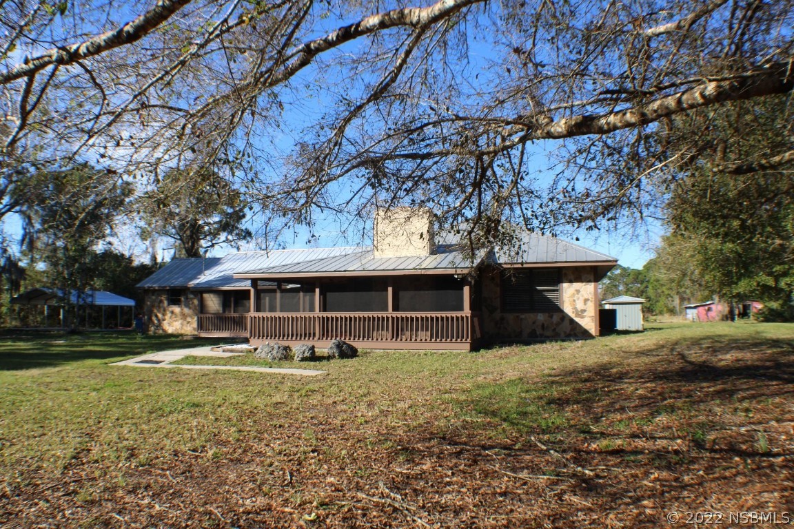 Undisclosed Address Edgewater, FL 32141 - Photo 5 of 37 a front view of a house with garden