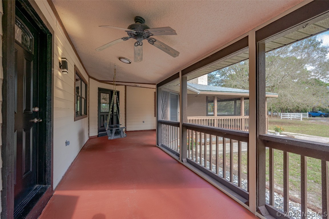 Undisclosed Address Edgewater, FL 32141 - Photo 8 of 37 a view of a porch with a floor to ceiling window