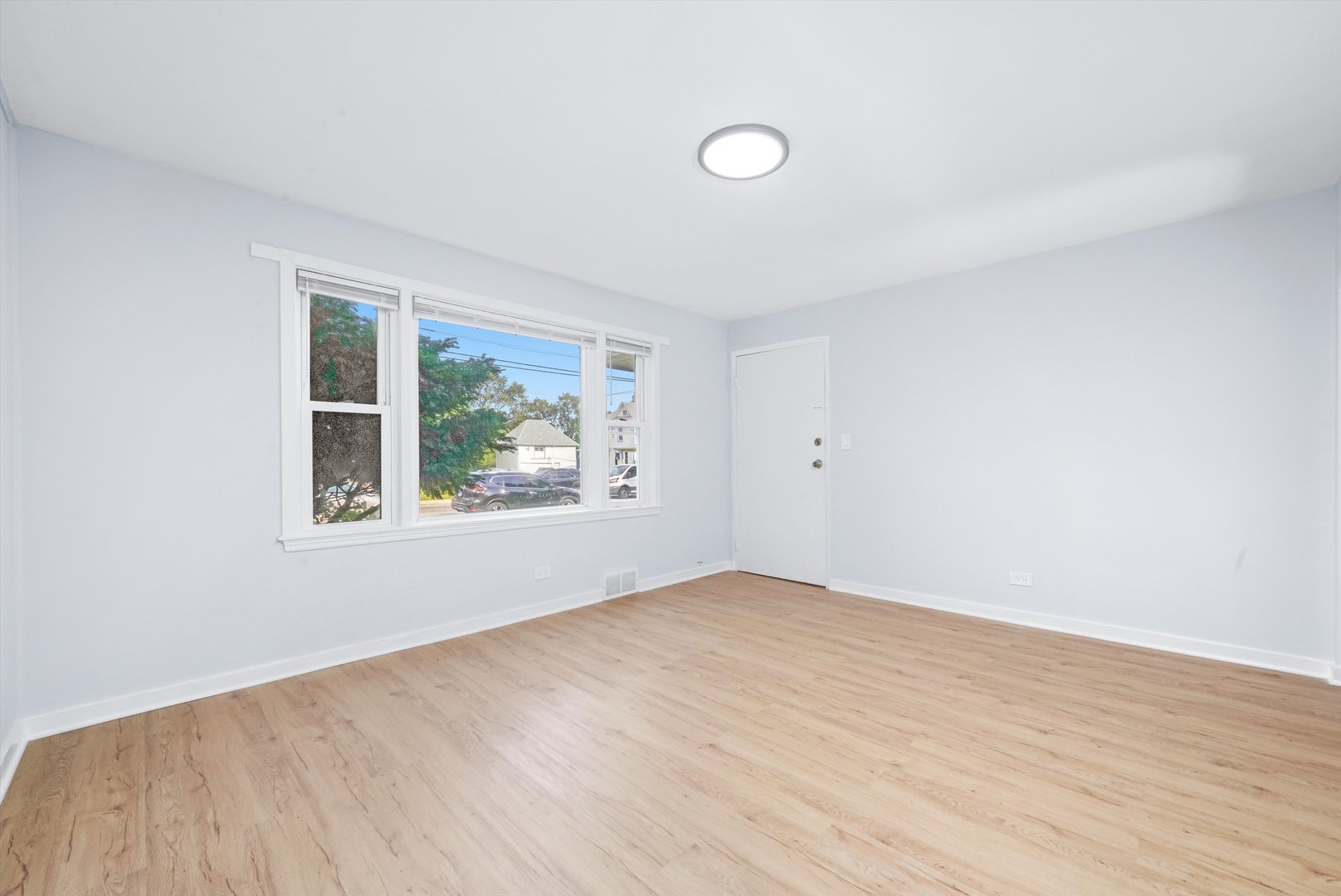 420 Prospect Boulevard, Unit 1N Elgin, IL 60120 - Photo 11 of 16 an empty room with wooden floor and windows